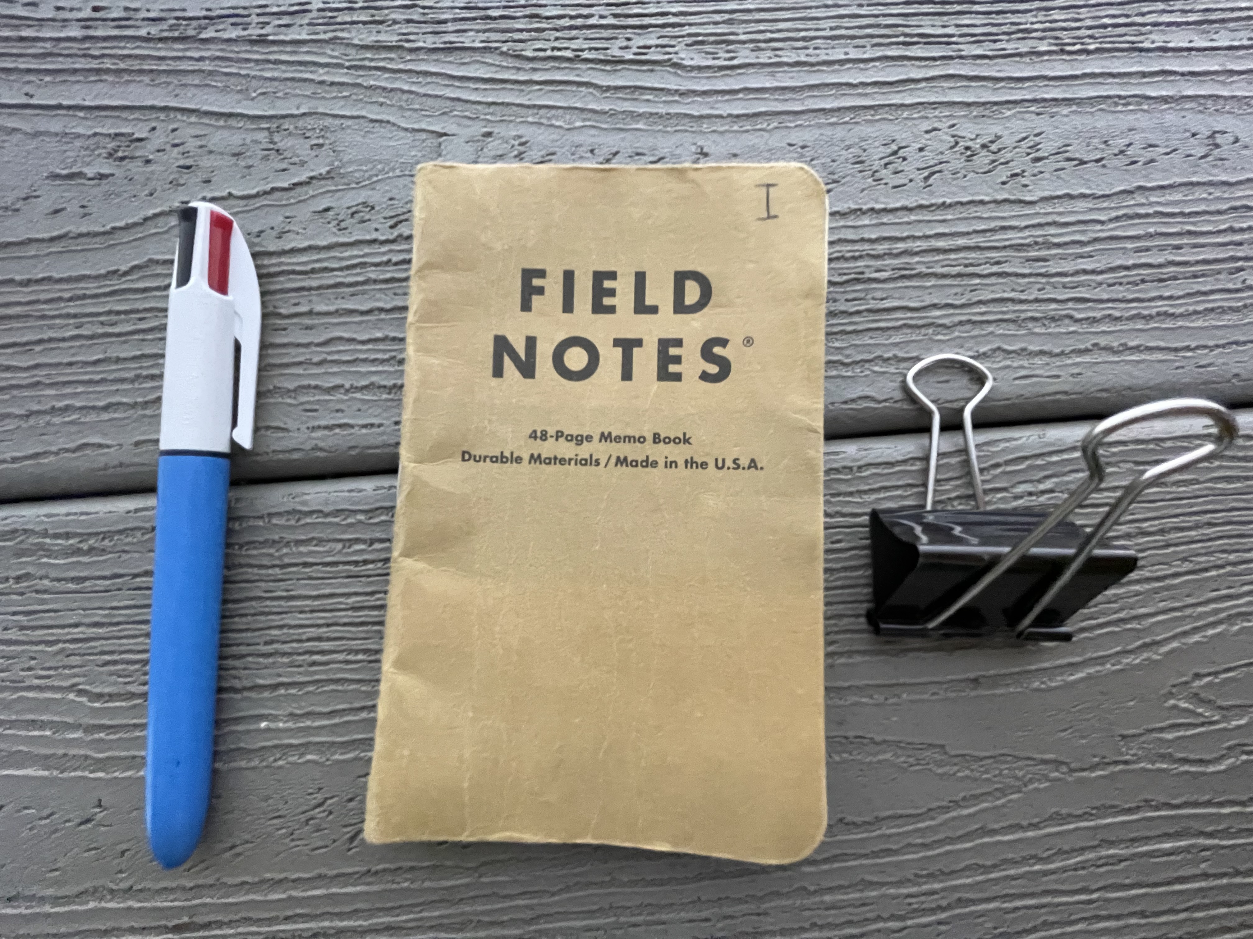 a pen, a notebook and a clip